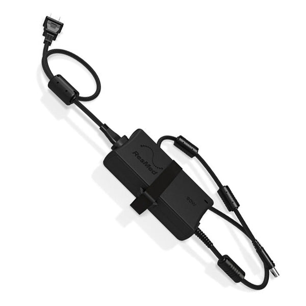 Black electronic device with cables on a white background