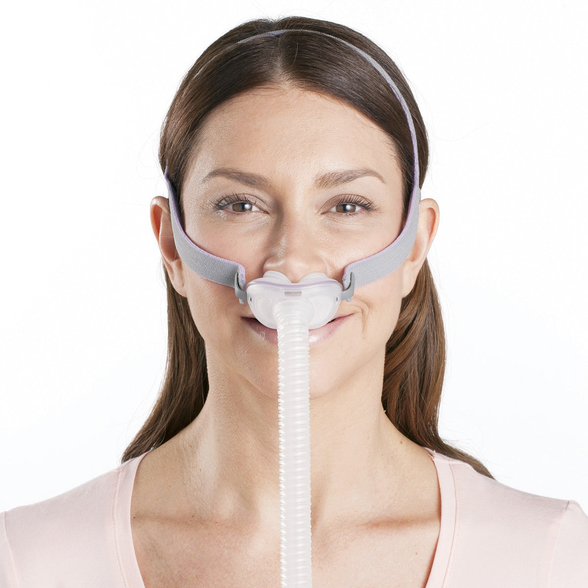 Woman wearing a CPAP mask with a white background