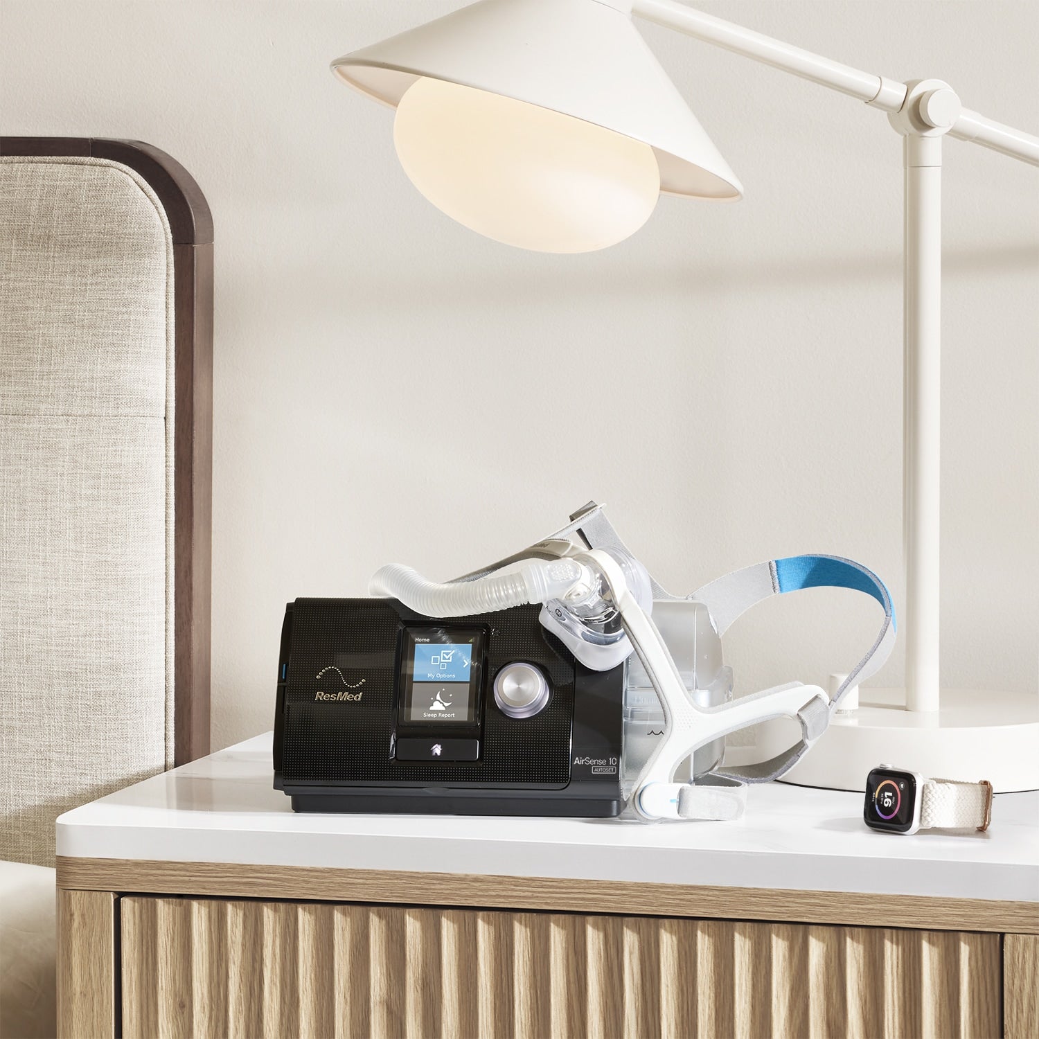 AirSense 10 Autoset CPAP Machine with a mask and a smartwatch showing myAir App on nightstand